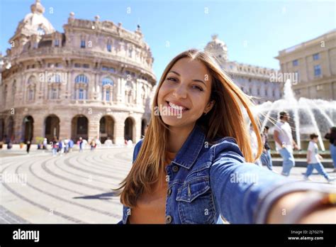 Traveling by Italy. Young traveling woman taking selfie at famous