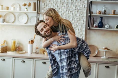 Satisfied European Millennial Guy With Stubble Holds Blonde Woman On