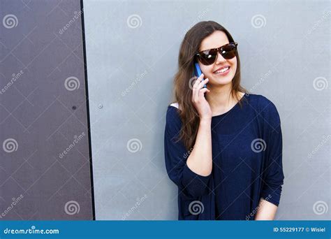 Cheerful Woman Talking On The Phone In The Street Casual Outfit Stock