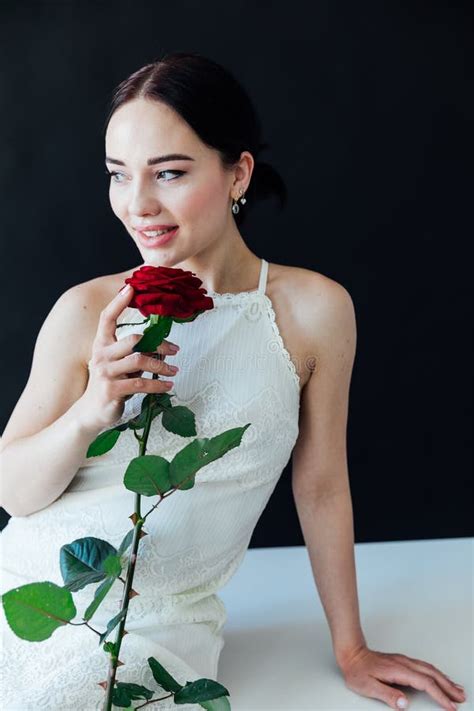 Beautiful Brunette In With A Red Rose Sits Near A Black Wall Stock Photo Image Of Body Happy
