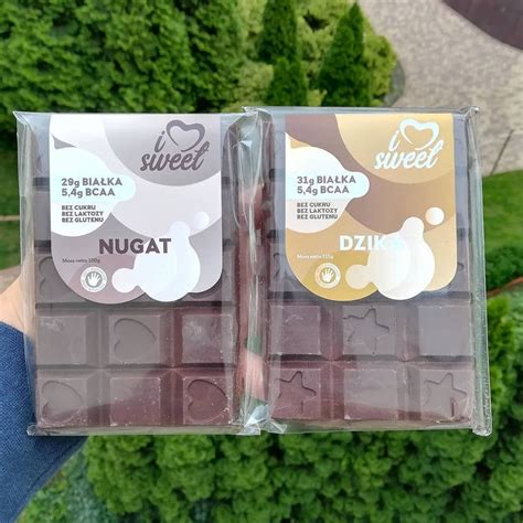 Two Packages Of Chocolates Are Shown In Front Of Some Trees