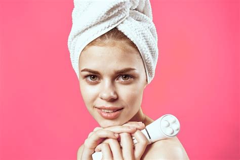 Premium Photo Woman With Towel On Head Naked Shoulders Skin Care Cosmetology Pink Background