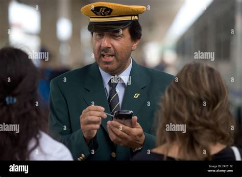 Trenitalia Platform Staff Helping Passengers At Milans Busy Mainline