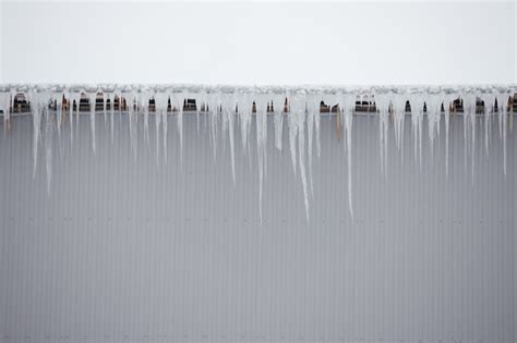 Premium Photo Very Large Icicles Hang From The Roof