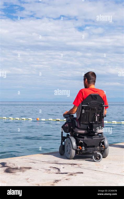 Man Sitting In A Wheelchair On The Beach Dangers Of Jumping Into Water