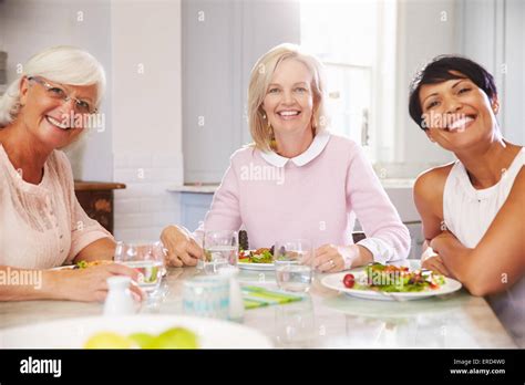 Portrait Of Mature Female Friends Enjoying Meal At Home Stock Photo Alamy