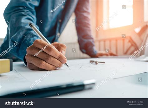 Engineers Pointing Building On Blueprint Using Stock Photo 1414134509