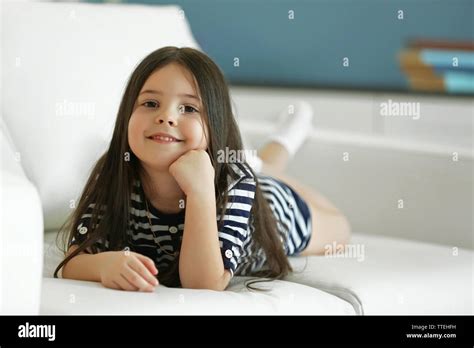 Beautiful Little Girl Lying On Sofa In The Room Stock Photo Alamy