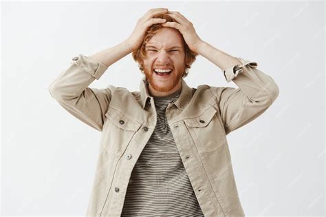 Free Photo Rejoicing Bearded Redhead Guy Posing Against The White Wall