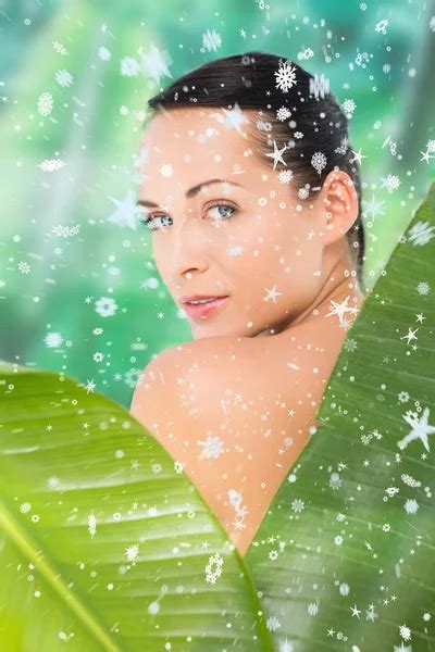 Beautiful Nude Brunette Posing With Green Leaves Stock Photo Wavebreakmedia 50044213