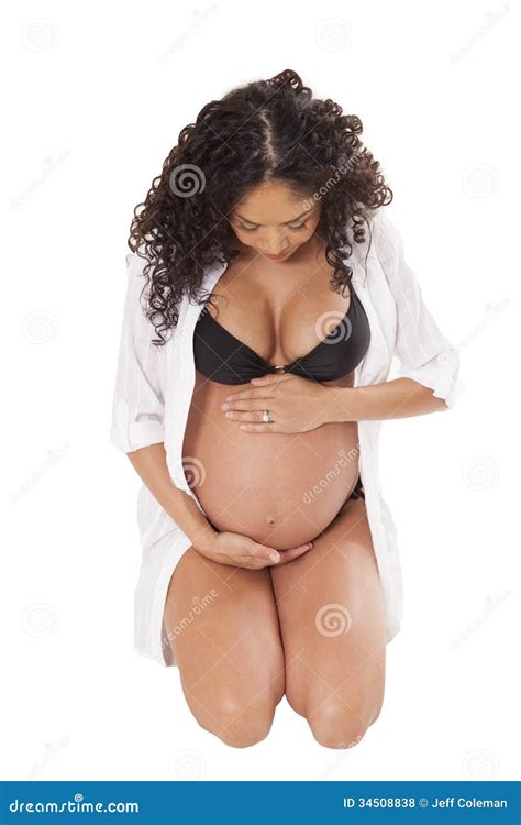 Pregnant Woman In A Bikini Looks Down At Her Swollen Belly Stock Photo Image Of Expecting
