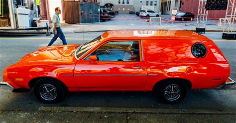 red station wagon parked  road  stock photo
