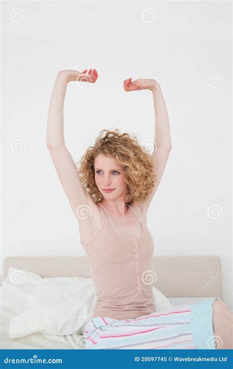 Attractive Blonde Female Stretching In Her Bedroom Stock Image Image