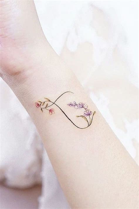 A Woman S Wrist Tattoo With Flowers On It