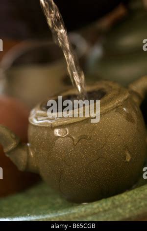 Hot Water Pouring Into Ceramic Teapot For Making A Tea Stock Photo Alamy