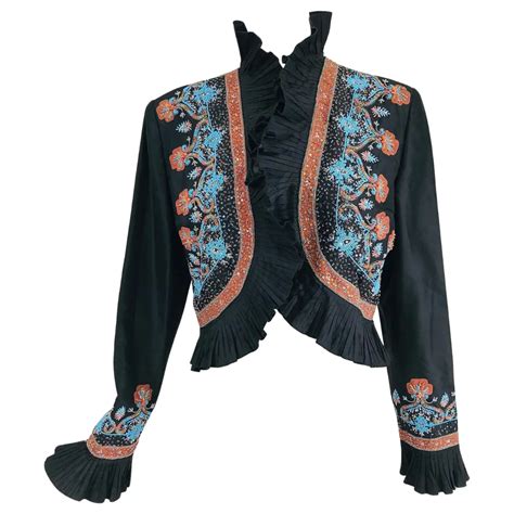 A Black Jacket With An Orange And Blue Design On The Front It Has