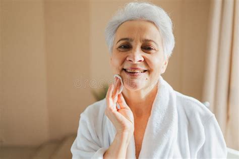 Mature Adult Old Woman Doing Daily Beauty Routine Removing Makeup With Cotton Pad Senior Woman