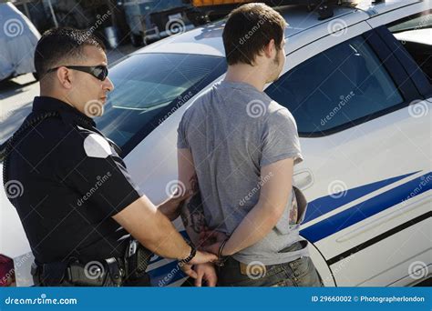 Police Officer Arresting Young Man Stock Photography Image 29660002