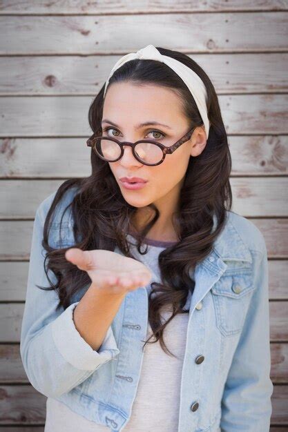 Premium Photo Brunette Blowing Kiss Against Wooden Planks