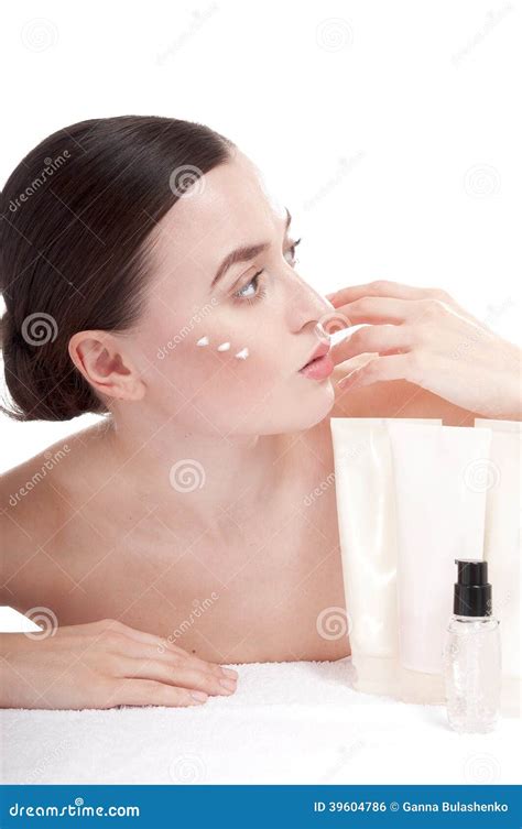 Sensual Woman Applying Cosmetic Cream Treatment On Her Face Stock