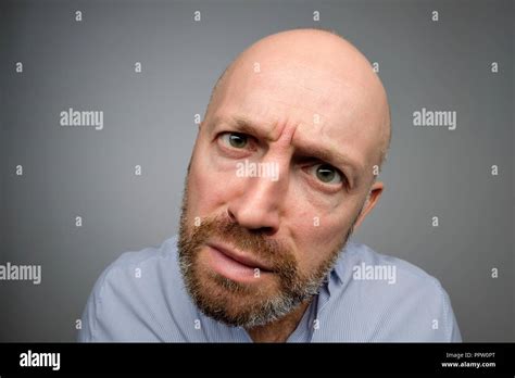 Bald Mature Guy In Gray Casual Shirt Discovering Hidden Camera Stock Photo Alamy