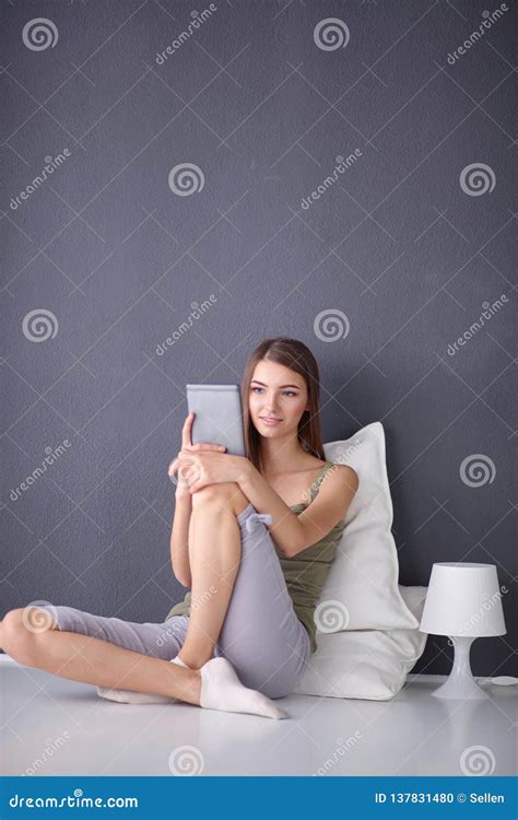 Pretty Brunette Woman Sitting On The Floor With A Pillow And Plane Table Stock Photo Image Of