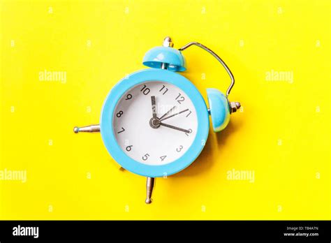 Ringing Twin Bell Vintage Classic Alarm Clock Isolated On Yellow
