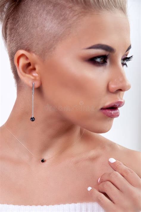 Closeup Blonde Model With Bright Make Up Bare Shoulders And Short Hair With Shaved Temples In
