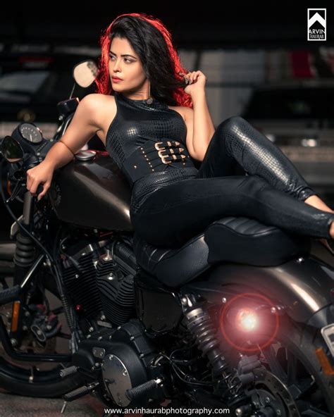 A Beautiful Woman Sitting On Top Of A Motorcycle