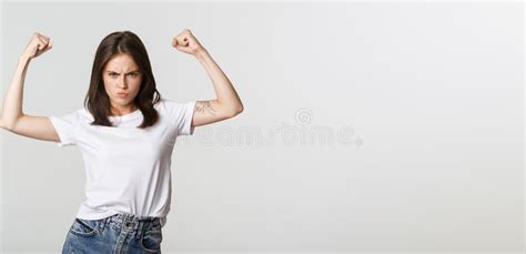 Serious Looking Confident Brunette Girl Flex Biceps Showing Strengths Stock Image Image Of