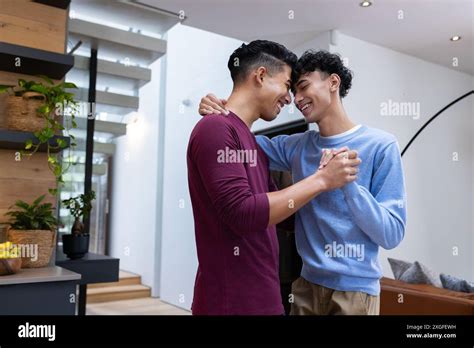 Smiling Male Gay Couple Dancing Together In Modern Home Enjoying Moment Stock Photo Alamy