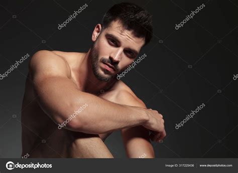 Dramatic Naked Guy Holding Arm On Knee Stock Photo By Feedough