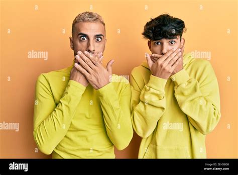 Homosexual Gay Couple Standing Together Wearing Yellow Clothes Shocked