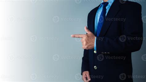 Businessman standing with finger pointing sideways to indicate