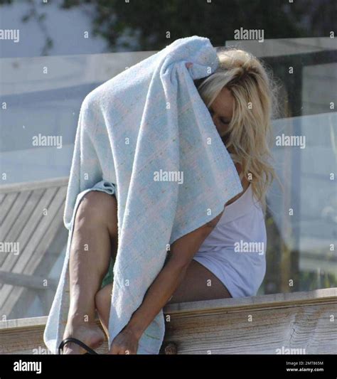 Baywatch Babe Pamela Anderson Tries To Hide From The Paparazzi Behind A Towel After Sunbathing