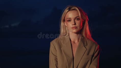 Naked Blonde Woman Lying In Bed With Blue Winter Cap Slow Motion Stock