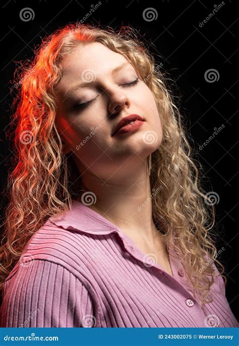 Studio Portrait Of A Year Old White Blonde Woman With Curling Hair Eyes Closed Stock Image