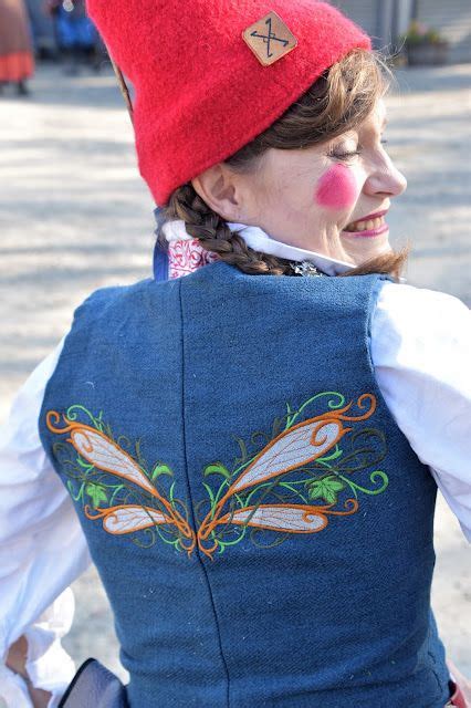 a woman wearing a red hat and blue vest