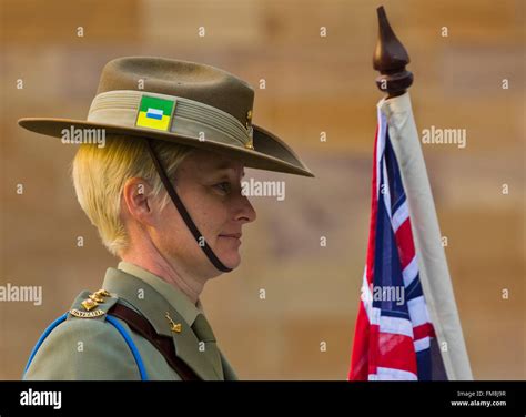 uniformed female australian army officer soldier  parade holding flag