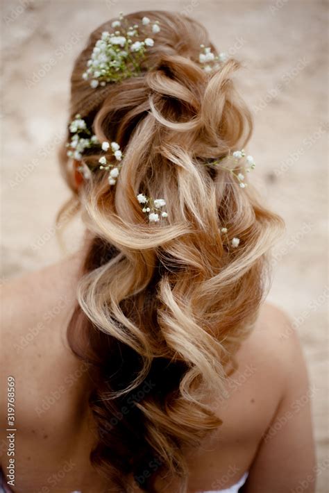 Blond Woman With Beautiful Log Hair On Nude Shoukders The Hairstyle Of Bride Qith Flowers
