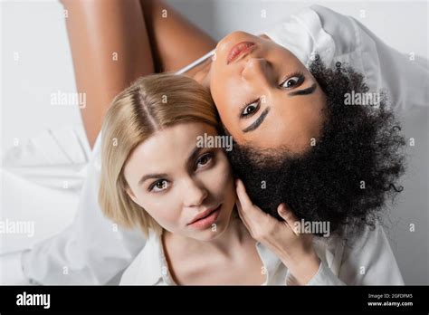 Top View Of Interracial Brunette And Blonde Models Looking At Camera On White Stock Photo Alamy