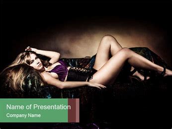 Studio Shot Of A Sensual Blonde Woman In Lingerie Lying On A Dark Background Bed PowerPoint