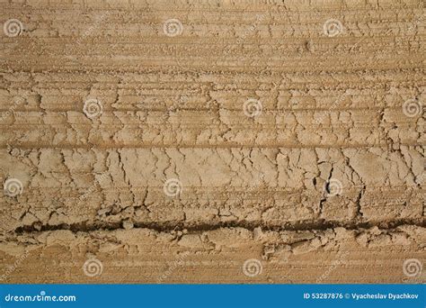 Macrophoto Of A Fragment Of An Unpaved Sandy Loamy Road With Traces Of