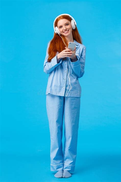 Hopeful And Amused Redhead Female In White Dress Holding Hands