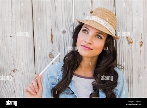Pretty Brunette Thinking And Smiling Stock Photo Alamy