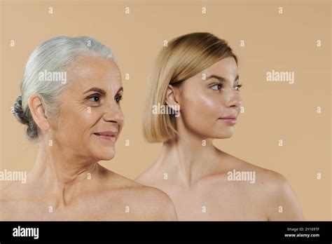 A Mature Woman Stands With Her Adult Daughter Sharing A Joyful