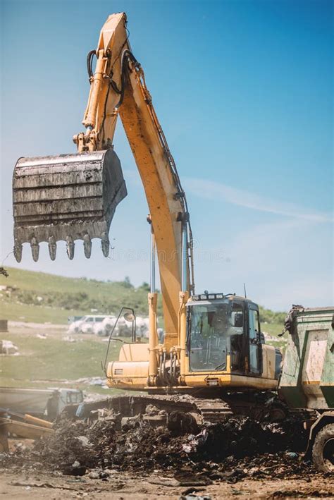 Heavy Duty Machinery Working On Site Excavator Loading Dumper Trucks