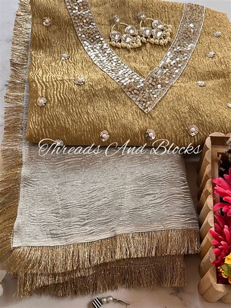 Silver Tissue Saree With Gold Blouse Threads And Blocks