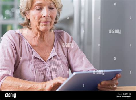 Mature Woman Touching Her Digital Tablet Stock Photo Alamy