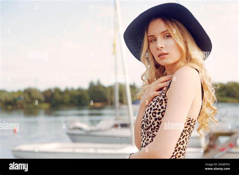 Girl On Background Of Yachts Sailing Boats Smiling Looking At The Camera Beautiful Blonde Is